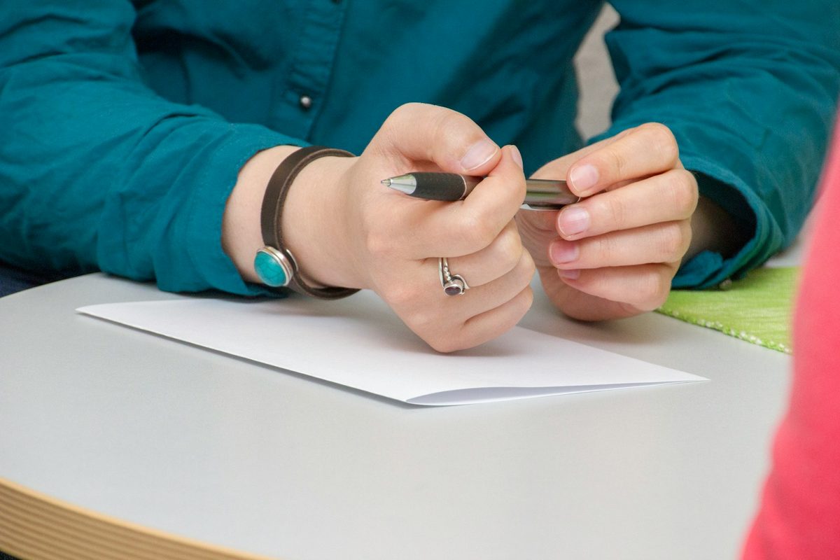 A person filling in a questionnaire during an assessment