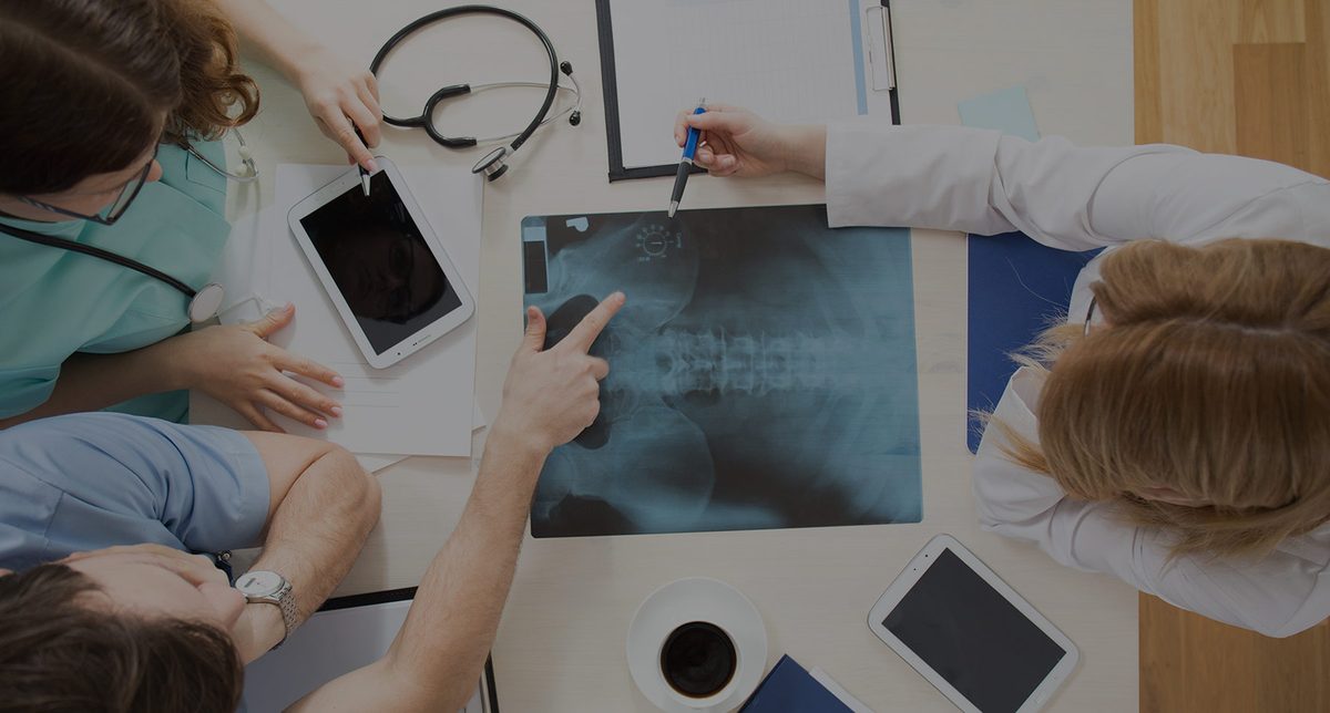 Two clinicians examining an X-ray